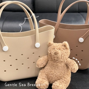 Detail of beige and brown EVA beach tote bags with ventilated holes and soft handles