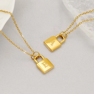 Minimalist gold-plated necklaces featuring delicate A and B initial lock pendants