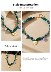 Detail of ethnic style green paisley fabric cord necklace with enamel flower pendants