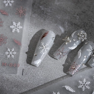 3D ultra-thin nail stickers with white snowflakes, feathers and rose gold accents