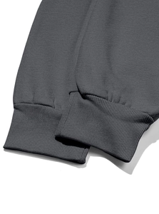 Detailed close-up of dark grey fleece hoodie ribbed cuffs with precise stitching finish