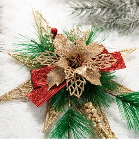 Detail of golden glitter flower with red ribbon and pine needles on snow background