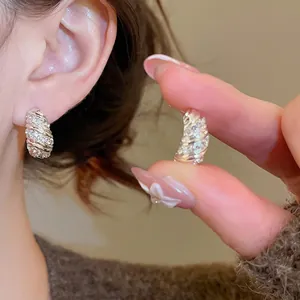 Sparkling silver twist huggie earrings with pavé zircons for elegant daily wear