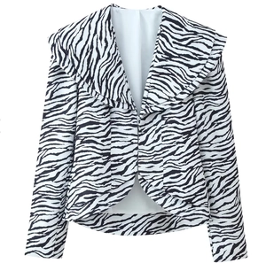Detail shot of zebra print blazer featuring classic wide lapels and crisp black-white pattern