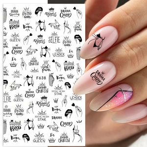 Detail of 3D nail art stickers with girl power slogans and crown designs on model nails