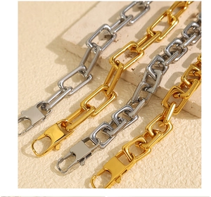 Detail of 18k gold and silver rectangle link chain necklaces with lobster clasps