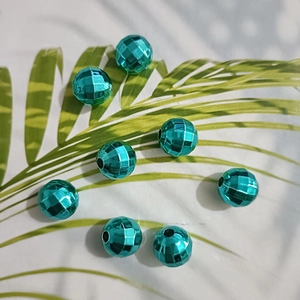 Close-up of faceted green plated round beads for DIY jewelry and necklaces