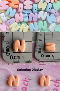 Macro shot of 11mm macaron resin alphabet beads with horizontal holes for DIY jewelry