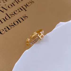 Gold plated adjustable open ring featuring H-letter design with sparkling zircon accents