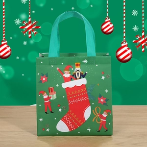 Green non-woven Christmas gift bag with nutcracker and elf festive cartoon patterns
