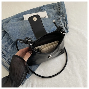 Detail view of the black leather shoulder bag interior showing phone and wallet storage