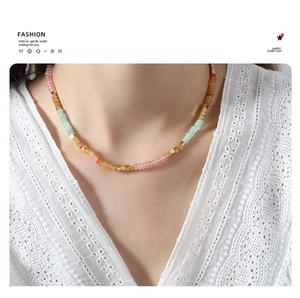 Detailed shot of handmade colorful amazonite beads and gold cube spacers on a necklace
