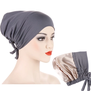 Close-up of gray headwrap featuring premium champagne satin lining and adjustable ties