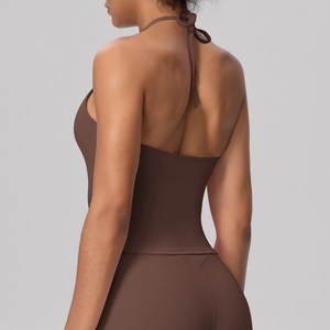 Detail of dark brown halter yoga top featuring tie-back straps and open back design