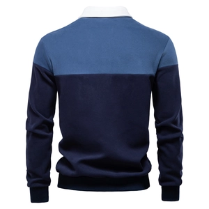 Detail view of the back of a men's long sleeve polo shirt with blue color block design