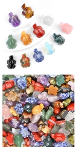 Detailed view of various colorful hand-carved natural gemstone and crystal turtle figurines