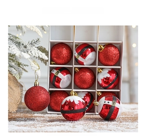 Close-up of 6cm red Christmas balls with glitter and Santa belt patterns in a gift box