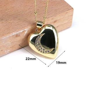 Detailed view of heart-shaped moon pendant necklace with 22mm by 19mm dimensions