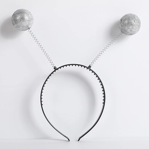 Detail of glitter silver foam balls on spring headbands for alien themed party costume