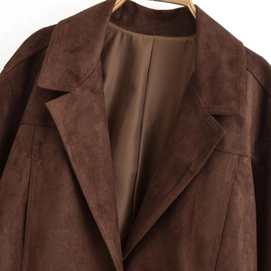 Classic dark brown suede jacket with wide lapel and satin lining on a wooden hanger