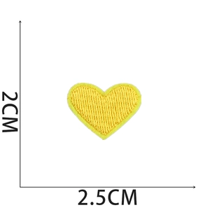 Detail view of a yellow heart embroidered patch showing dimensions 2cm x 2.5cm on white backdrop