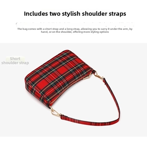 Detail view of red plaid baguette bag showing two detachable straps for multiple carry styles