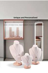 Detailed display of circular and fan-shaped necklaces on pink elegant jewelry neck busts