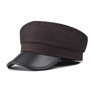 Detail of vintage baker boy hat featuring textured fabric and premium PU leather brim