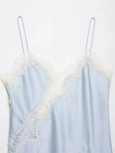 Detailed close-up of light blue satin camisole with delicate white lace trim and straps
