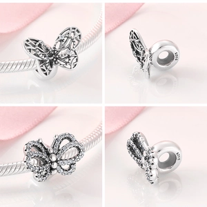 Detailed views of S925 sterling silver butterfly charms with sparkling cubic zirconia