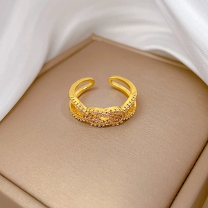 Detailed close-up of a gold adjustable twisted knot ring with micro-pave white zircons