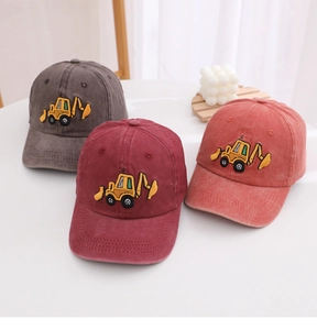 Detail of vintage washed cotton baseball caps with embroidered yellow excavators in three colors