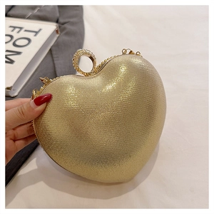 Detailed view of heart-shaped evening clutch with sparkling finish and rhinestone ring clasp