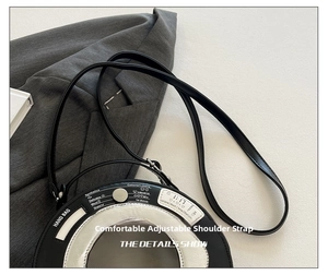 Detail of adjustable shoulder strap connection on a washing machine shaped handbag