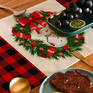 Christmas table runner with snowman wreath and red plaid pattern on linen texture