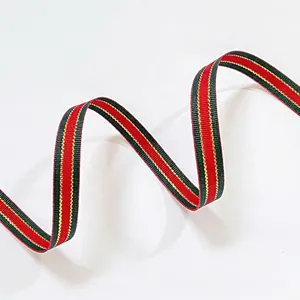Close-up of red and green striped grosgrain ribbon with gold metallic edge stitching