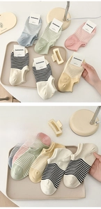 Detailed close-up of combed cotton low-cut striped socks in soft pastel color palette