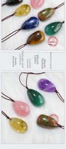 Detailed view of various natural teardrop crystal pendants with brown braided cords