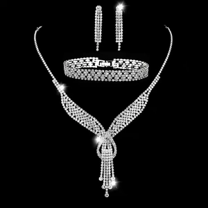 Elegant bridal silver rhinestone necklace, bracelet and earrings jewelry set on black background