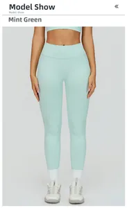 Detail of high-waist mint green seamless yoga leggings with compression knit fabric