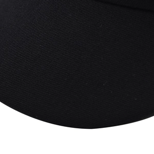 Close-up of the black knitted fabric texture and fine mesh pattern of the octagonal hat