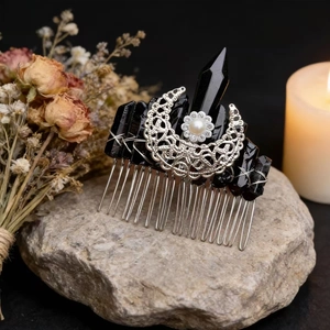 Handmade moon hair comb with black crystals and silver crescent moon on a natural stone base