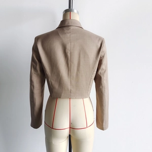 Rear view of coffee brown tailored blazer jacket with a slim waist fit on mannequin