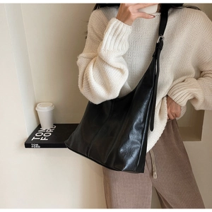 Chic black soft leather hobo bag for women worn over shoulder with high capacity for daily use