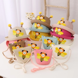 Detail of children's straw hat and matching bag set featuring cute 3D bee motifs