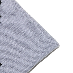 Macro detail of lavender knit fabric with black star pattern on a warm winter hat