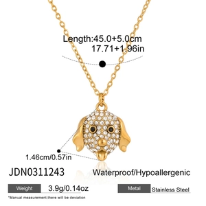 Macro view of gold stainless steel necklace with dog head pendant and crystal stones