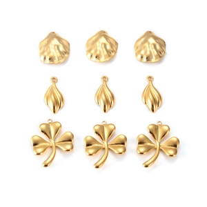 Set of gold stainless steel pendants featuring clover, leaf, and shell designs for jewelry