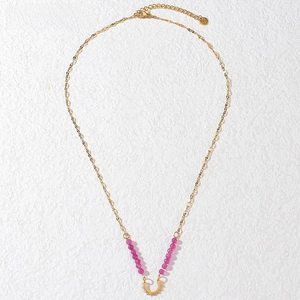Detail of golden bead necklace with purple stones and a sun pendant on white background