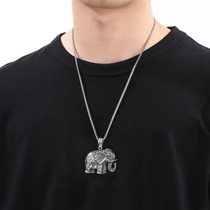 Hip hop style silver elephant pendant necklace with sparkling rhinestones on a male model